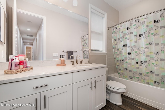 7690 Kerrington Dr, Melbourne, FL 32940 - full bathroom with shower / tub combo with curtain, vanity, hardwood / wood-style flooring, and toilet