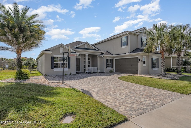 7690 Kerrington Dr, Melbourne, FL 32940 - view of front of home featuring a garage and a front lawn