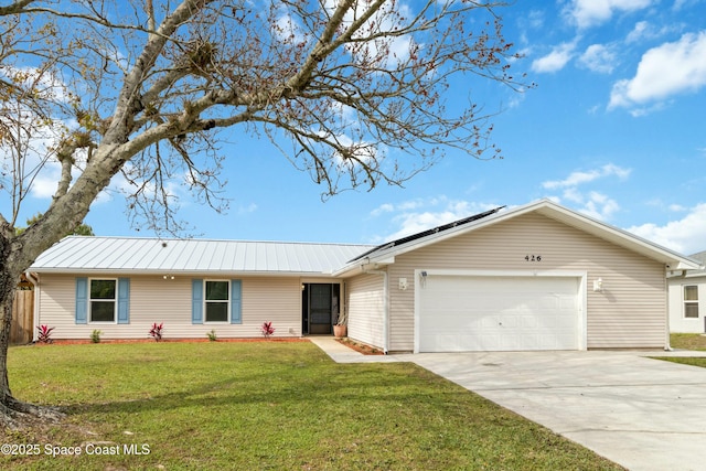 single story home with a front lawn, a garage, and solar panels