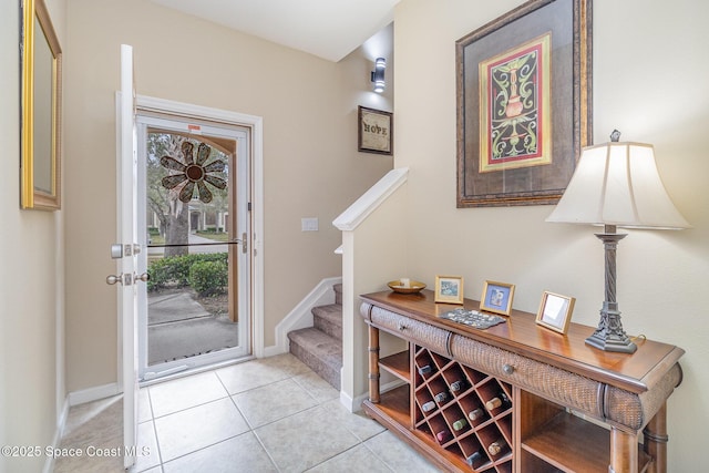 foyer entrance with light tile patterned floors