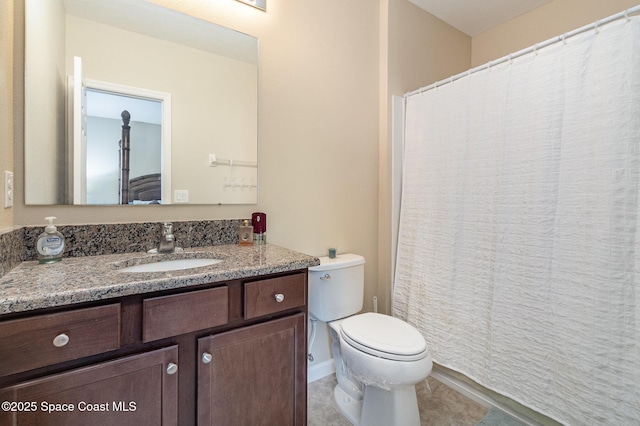 bathroom with toilet, tile patterned flooring, and vanity