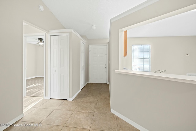 corridor featuring light tile patterned flooring