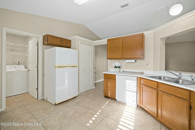 kitchen with washer / dryer, sink, light tile patterned floors, and white appliances