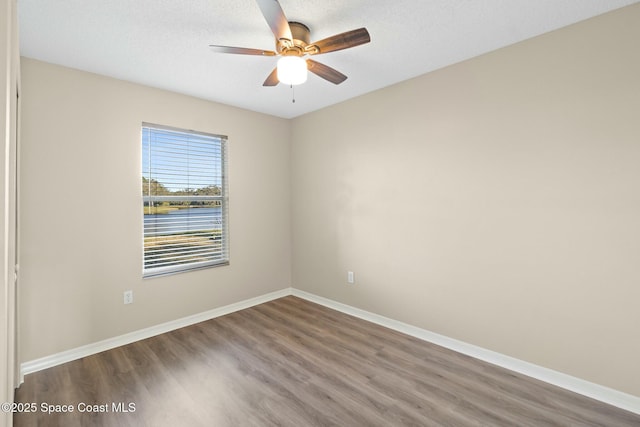 empty room with hardwood / wood-style flooring, a textured ceiling, and ceiling fan