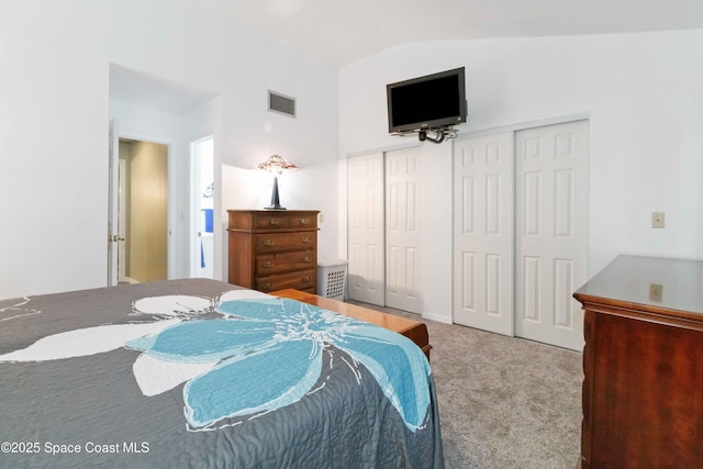 carpeted bedroom with lofted ceiling