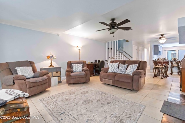 living room with ceiling fan, light tile patterned flooring, and ornamental molding