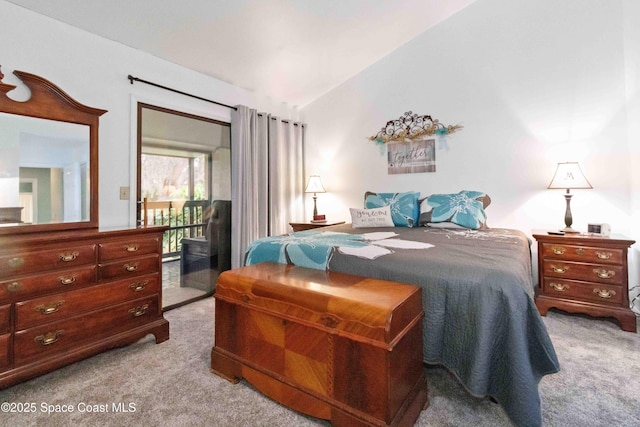 bedroom featuring lofted ceiling and light carpet