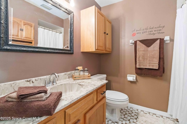 bathroom featuring toilet, vanity, and tile patterned floors