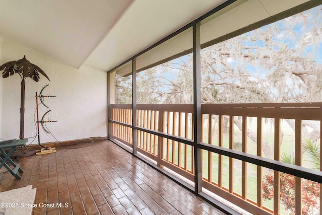 unfurnished sunroom with vaulted ceiling