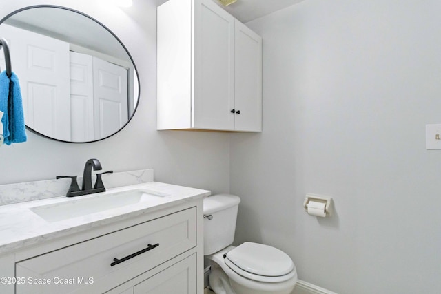 bathroom with toilet and vanity