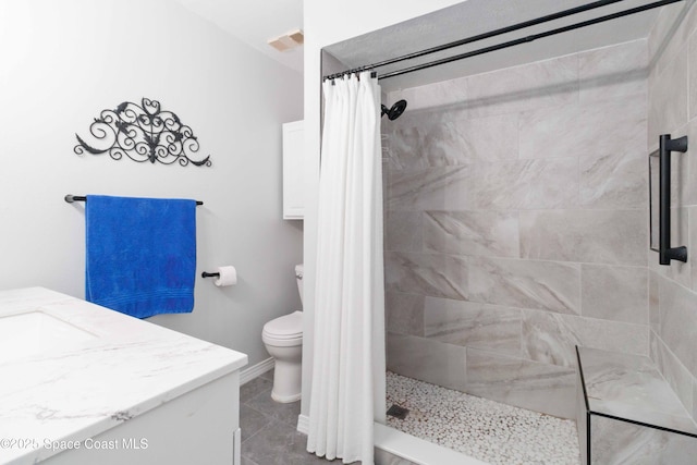 bathroom with tile patterned floors, toilet, vanity, and a shower with shower curtain