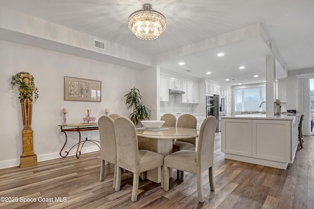 dining room featuring a chandelier and hardwood / wood-style floors