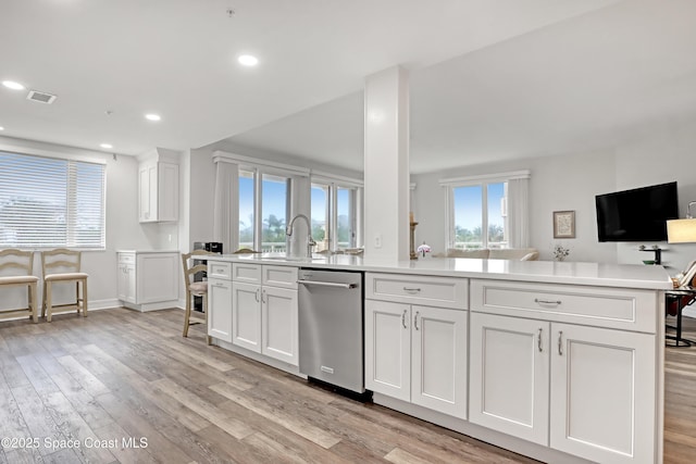 kitchen featuring light hardwood / wood-style floors, sink, white cabinets, and dishwasher