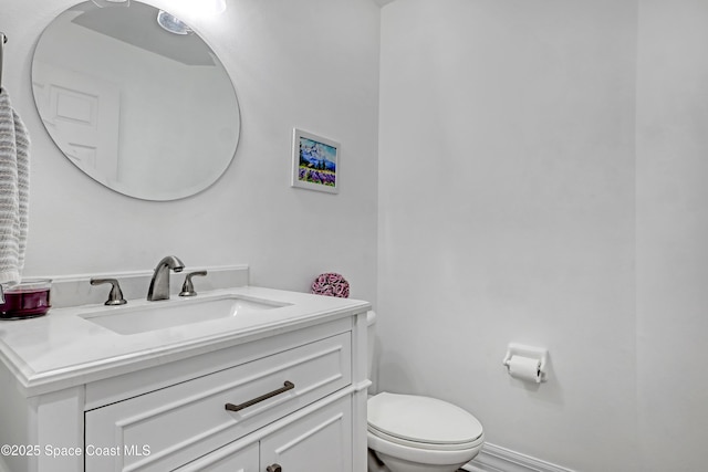 bathroom featuring toilet and vanity