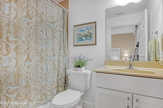 bathroom featuring toilet and vanity