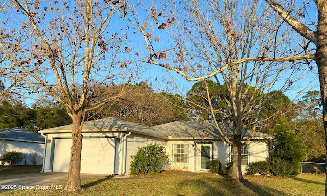 ranch-style home with stucco siding, an attached garage, driveway, and a front lawn