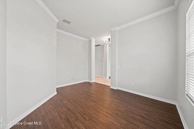 spare room with dark hardwood / wood-style flooring and ornamental molding