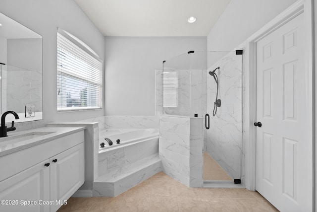 bathroom with independent shower and bath, tile patterned floors, and vanity