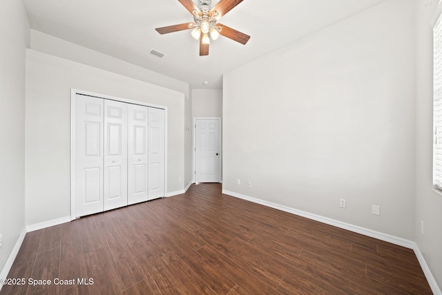 unfurnished bedroom featuring ceiling fan, a closet, and dark hardwood / wood-style flooring