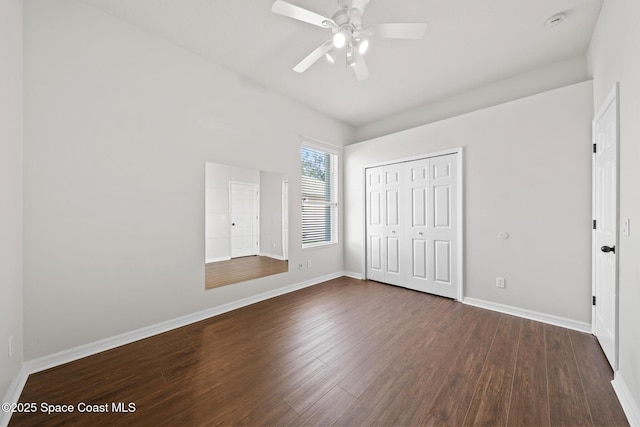 unfurnished bedroom with ceiling fan, a closet, and dark hardwood / wood-style floors