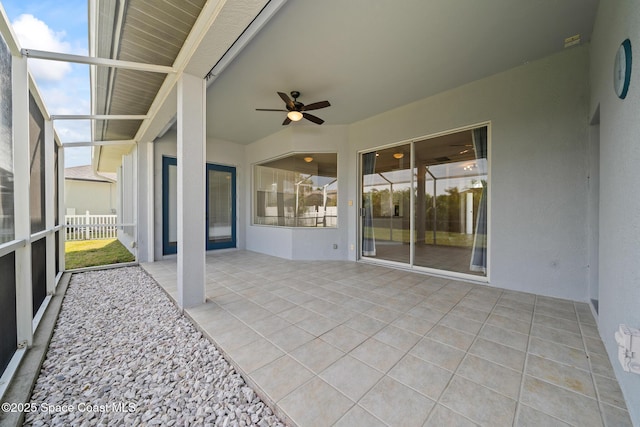 view of patio / terrace with ceiling fan and a lanai