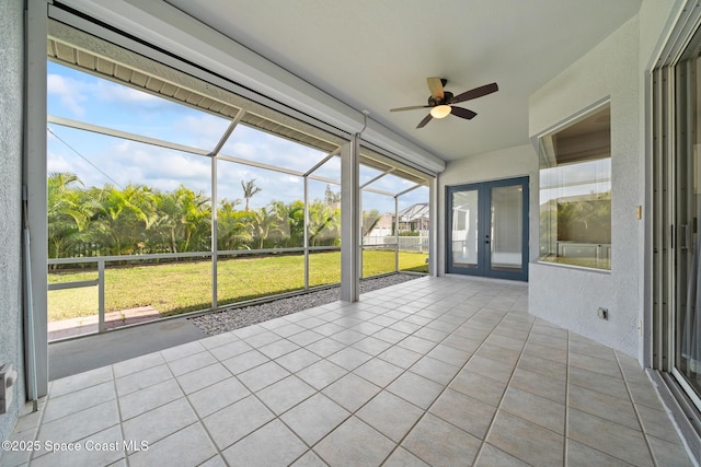 unfurnished sunroom featuring ceiling fan