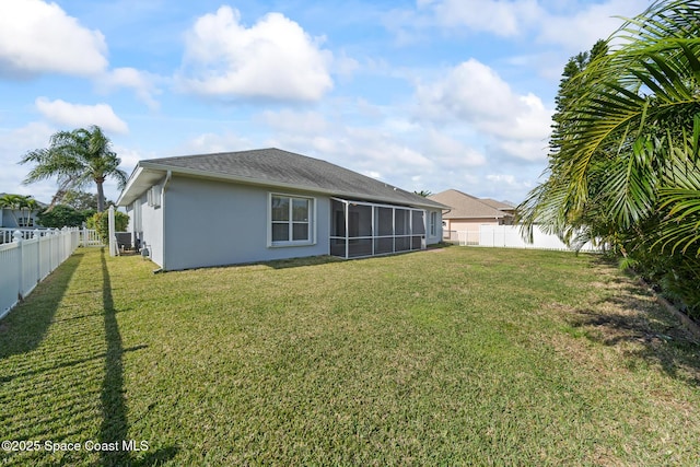 rear view of property featuring a yard