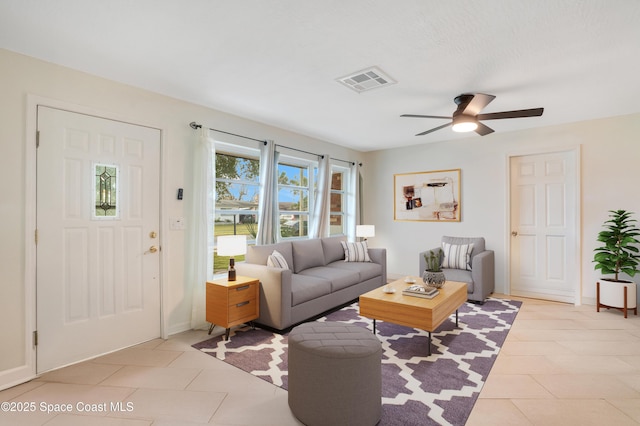 tiled living room with ceiling fan