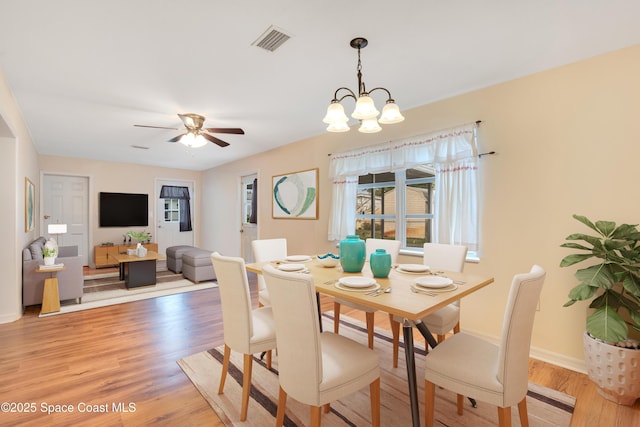 1008 Jersey St, Cocoa, FL 32927 - dining room with light wood-style flooring, a chandelier, and ceiling fan