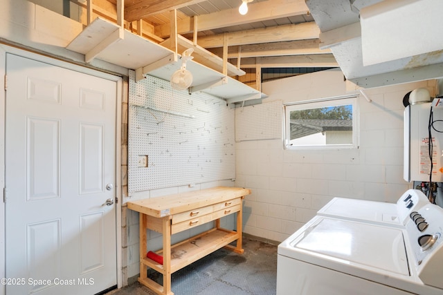 1008 Jersey St, Cocoa, FL 32927 - washroom with washer and dryer, concrete block wall, and tankless water heater