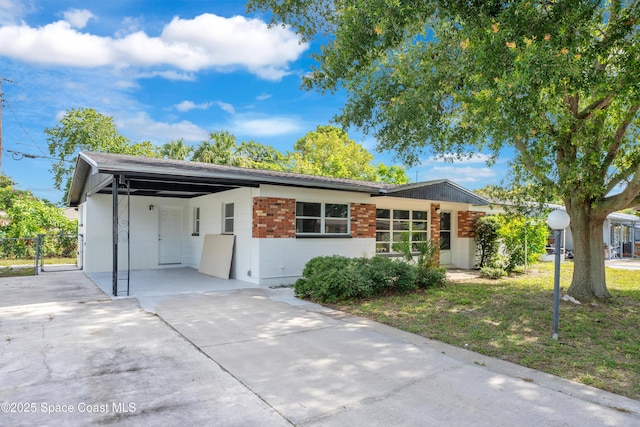 1008 Jersey St, Cocoa, FL 32927 - ranch-style house featuring driveway, a carport, concrete block siding, and roof with shingles