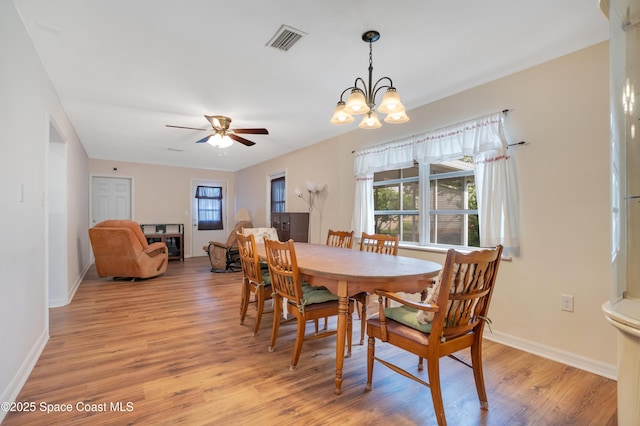 1008 Jersey St, Cocoa, FL 32927 - dining space with light wood-type flooring, healthy amount of natural light, a ceiling fan, and a chandelier