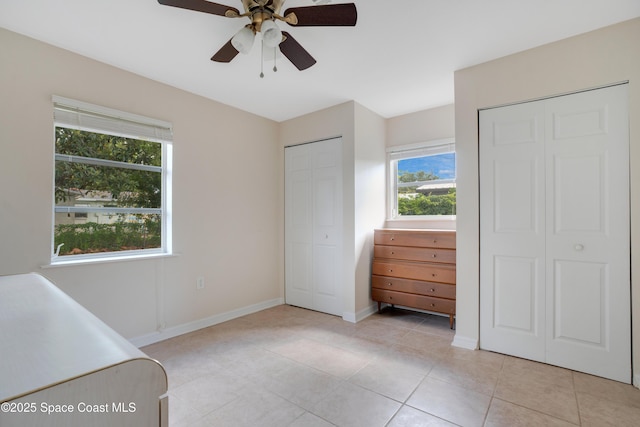 1008 Jersey St, Cocoa, FL 32927 - unfurnished bedroom with two closets, light tile patterned floors, and a ceiling fan