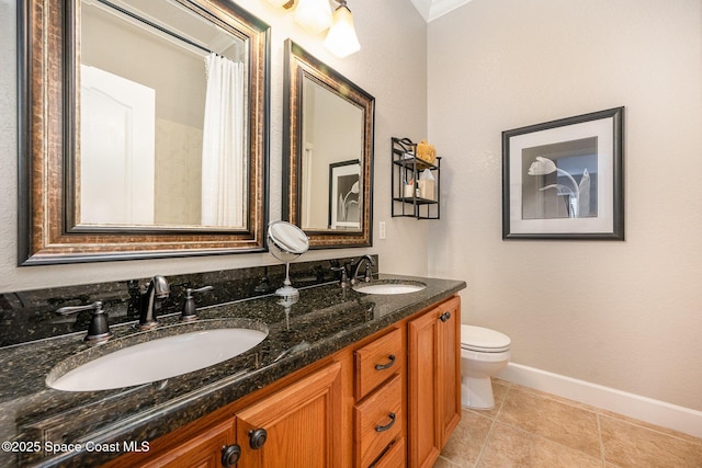 bathroom featuring tile patterned floors, toilet, vanity, and ornamental molding