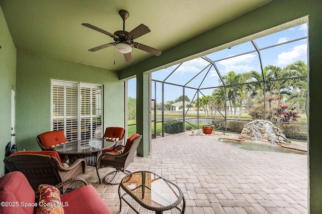 sunroom / solarium featuring ceiling fan