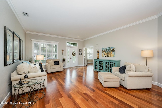 living room featuring crown molding and hardwood / wood-style flooring