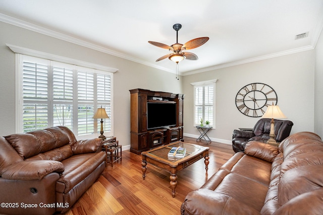 living room featuring ceiling fan, crown molding, and light hardwood / wood-style flooring