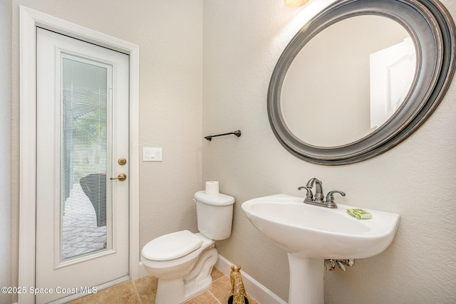 bathroom featuring toilet and tile patterned flooring