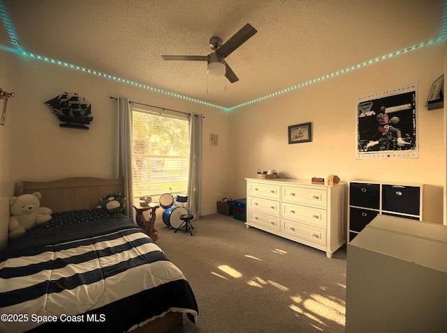 carpeted bedroom with a textured ceiling and ceiling fan