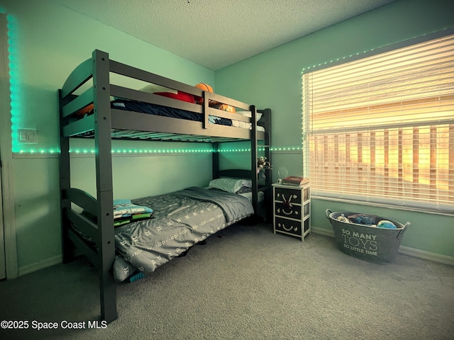 carpeted bedroom featuring a textured ceiling