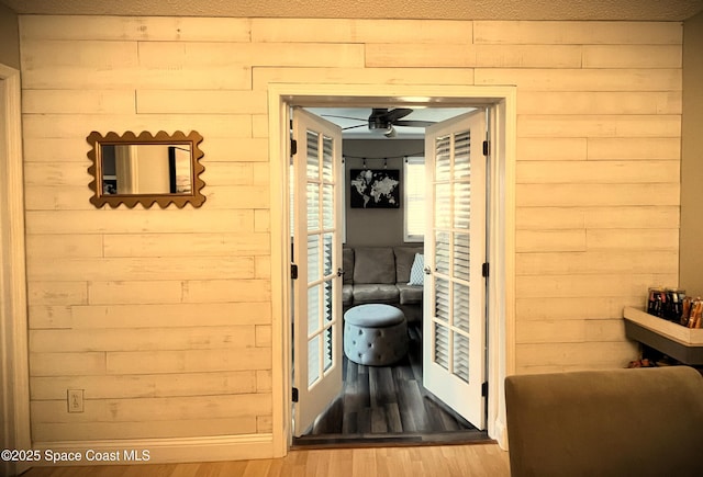 hall with a wealth of natural light and light hardwood / wood-style flooring