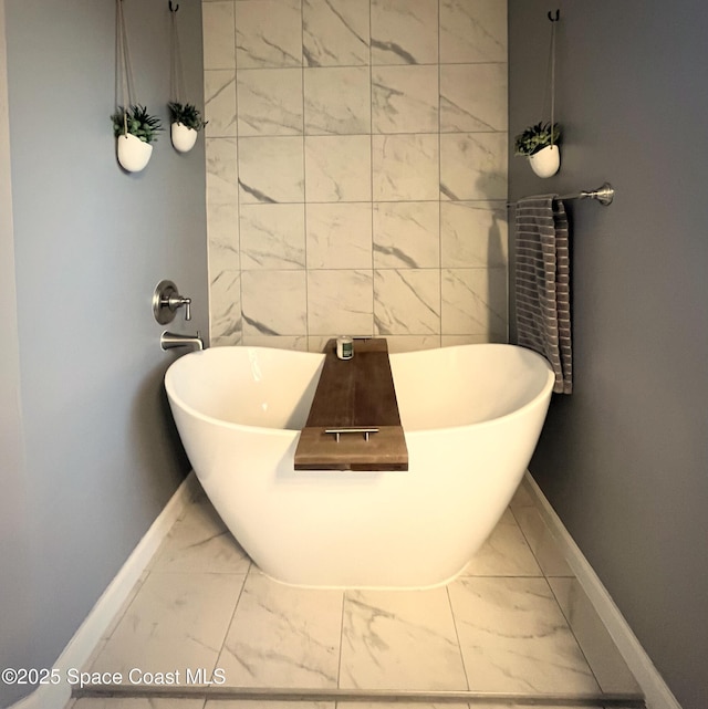 bathroom featuring tile walls and a bathtub