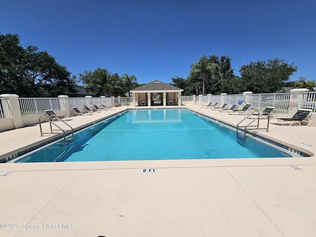 pool with fence and a patio area