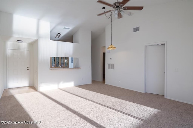 unfurnished living room with high vaulted ceiling, light colored carpet, and ceiling fan