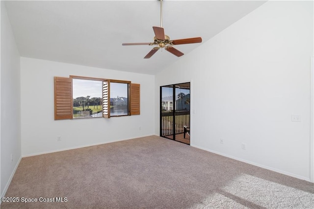 carpeted spare room with ceiling fan and high vaulted ceiling