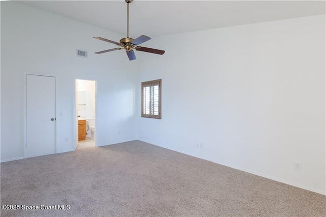 carpeted empty room featuring ceiling fan and high vaulted ceiling