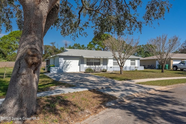 ranch-style house with a garage and a front yard