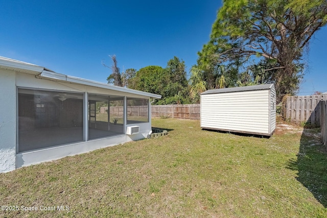 view of yard with a sunroom and a storage unit