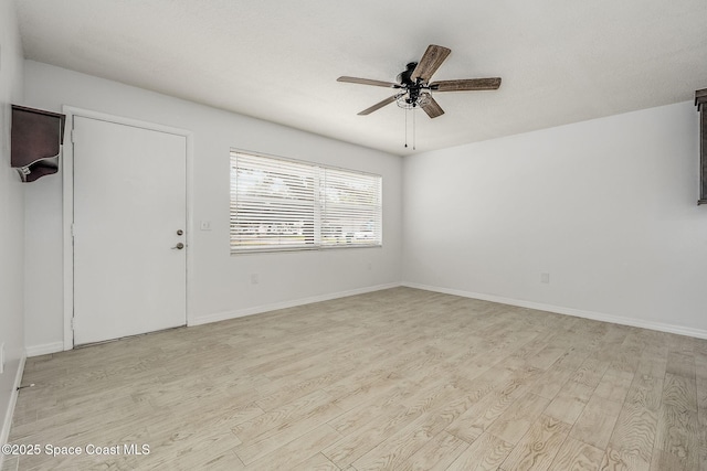 empty room with ceiling fan and light wood-type flooring