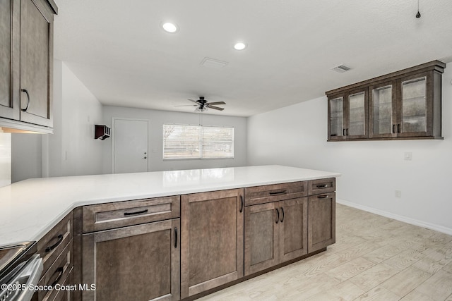 kitchen with electric stove, ceiling fan, dark brown cabinets, and light wood-type flooring